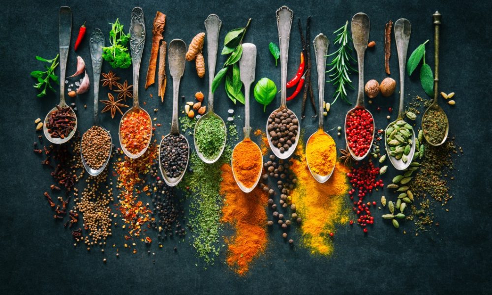 Colourful various herbs and spices for cooking on dark background